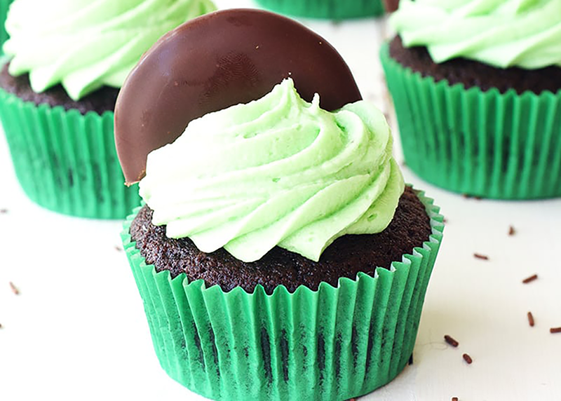 Chocolate cupcake with green mint icing and a mint cookie on top